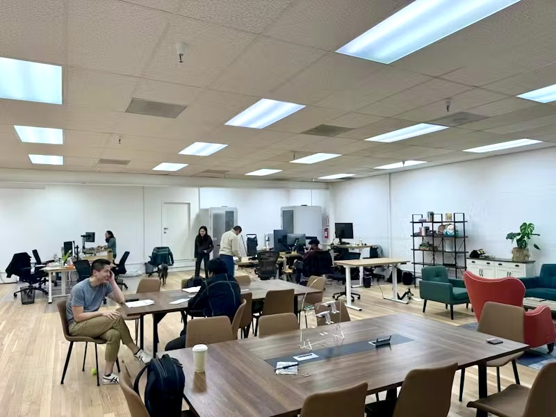 The Patchworks workspace, with desks, a long conference table and people at work.